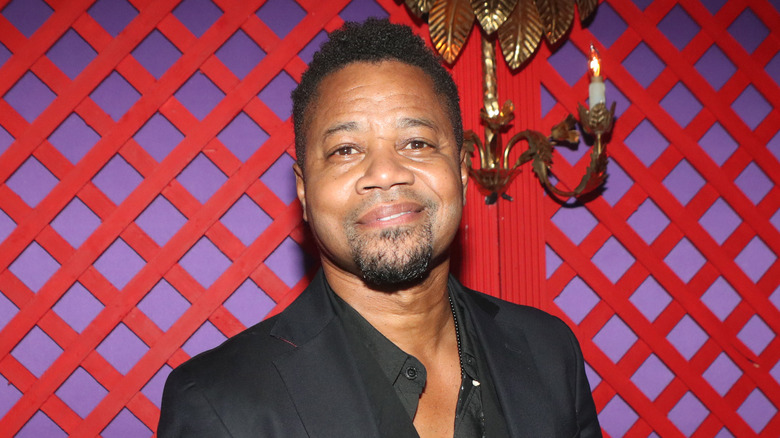 Cuba Gooding Jr. smiling closed mouth with his chin tilted