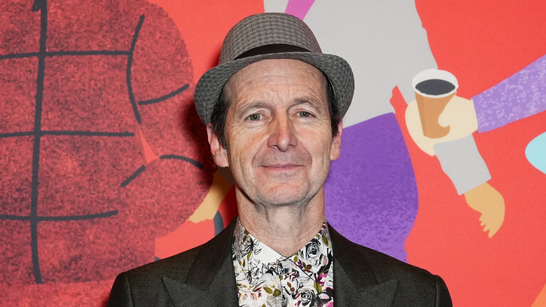 Denis O'Hare smiling closed mouth on the red carpet