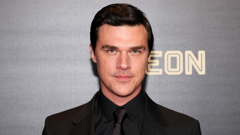 Finn Wittrock stares at the camera