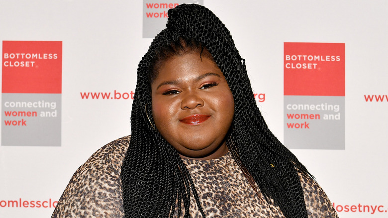 Gabourey Sidibe smiling closed mouthed at the camera