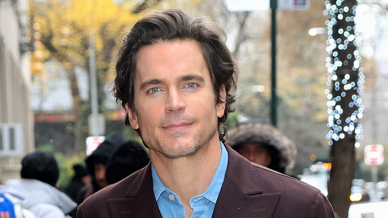 Matt Bomer smiling closed mouth at the camera