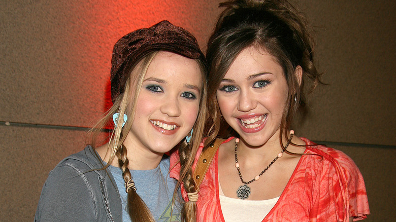 Miley Cyrus and Emily Osment pose together