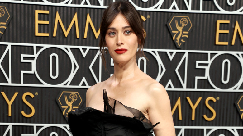 Lizzy Caplan wearing a strapless gauzey black gown