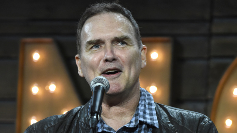 Norm Macdonald onstage with microphone