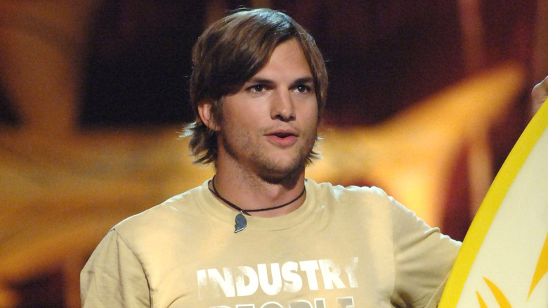 Young Ashton Kutcher in a yellow shirt