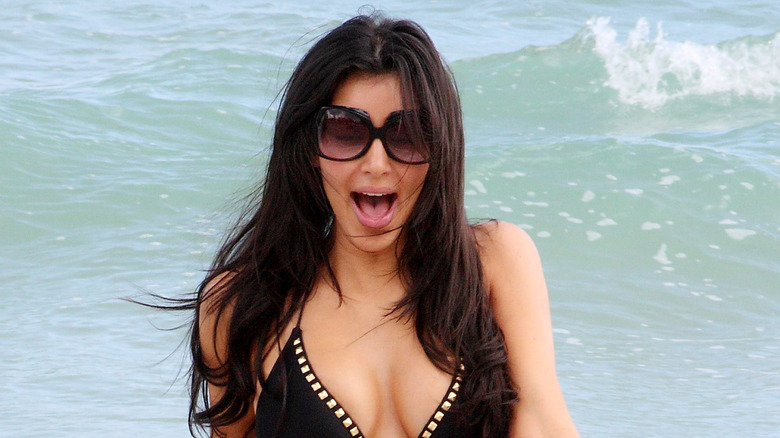 Kim Kardashian walking in water, mouth agog