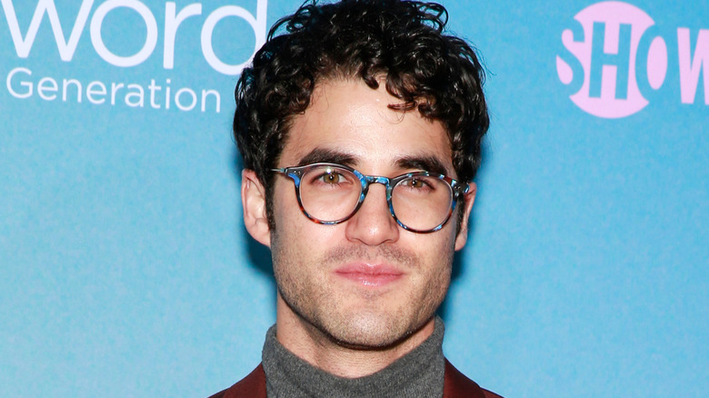 Darren Criss smiling, wearing glasses