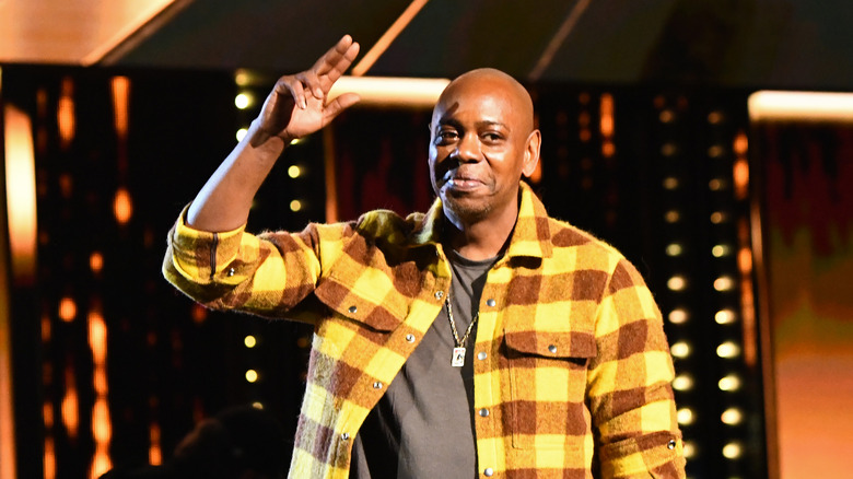 Dave Chappelle raising his hand