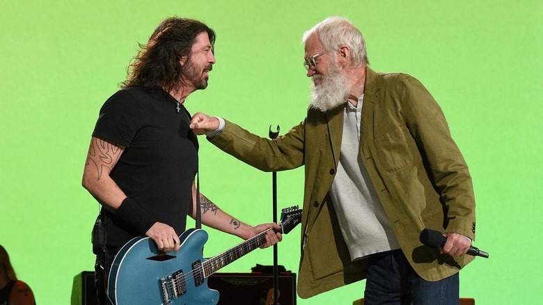 Dave Grohl and David Letterman playfully interacting on set