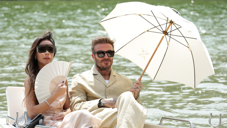 Victoria and David Beckham sitting in a boat