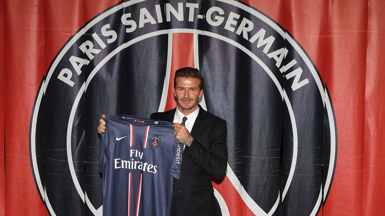 David Beckham holding a Paris Saint-Germain jersey