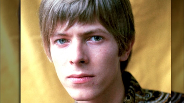 Young David Bowie looking at camera