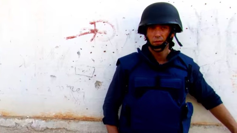 David Muir wearing a helmet and flak jacket