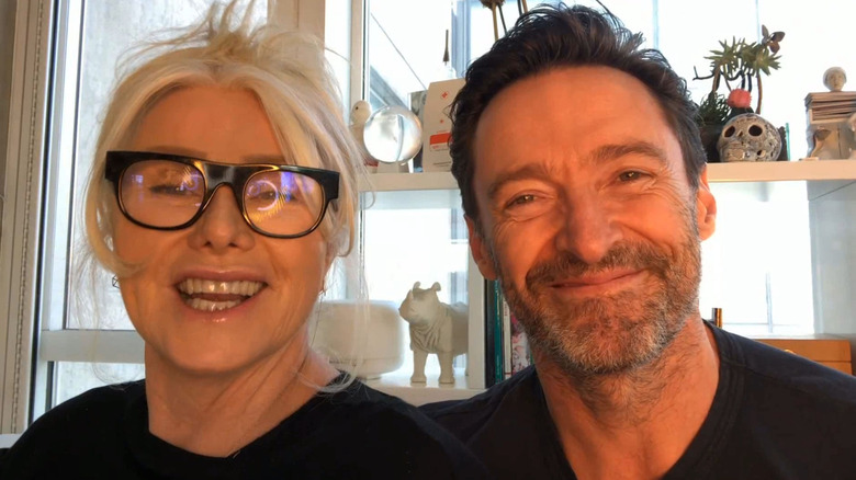 Deborra-Lee Furness and Hugh Jackman smiling in their home in 2021