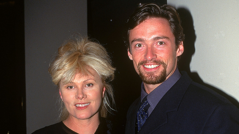 Deborra-Lee Furness and Hugh Jackman posing and smiling together in 1997