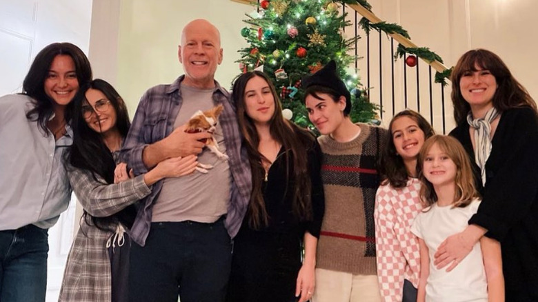 Demi Moore and Emma Heming pose by the Christmas tree with family