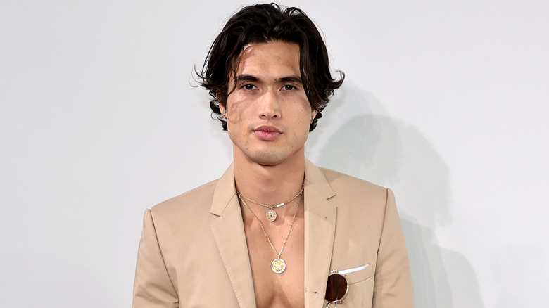 Charles Melton posing at an event