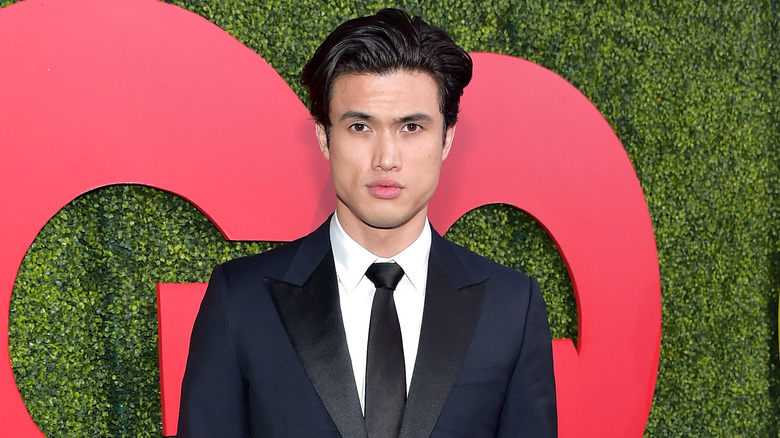 Charles Melton posing at an event