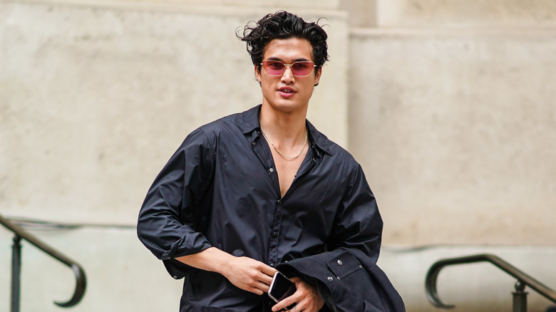 Charles Melton walking down steps