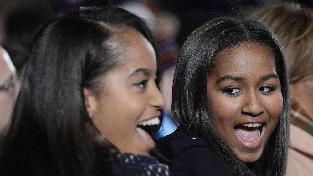 Sasha Obama smiling with sister Malia 