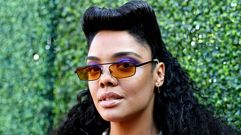 Tessa Thompson poses in sunglasses on the red carpet