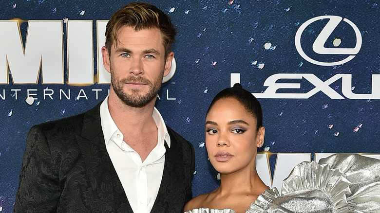 Chris Hemsworth and Tessa Thompson posing on the red carpet