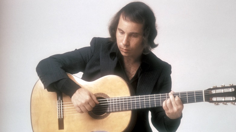 Paul Simon poses with guitar