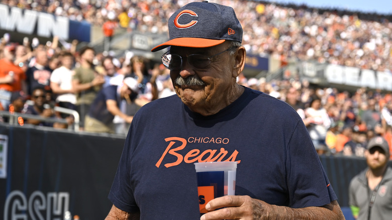 Dick Butkus holding a cup