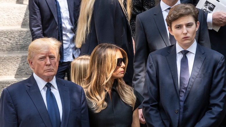 The Trump family with somber expressions