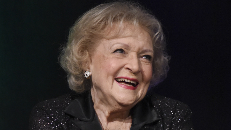 Betty White sits on stage at an event