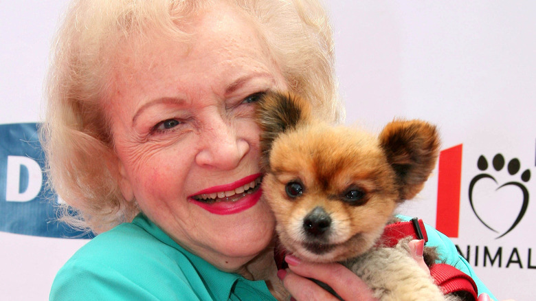 Betty White holding puppy