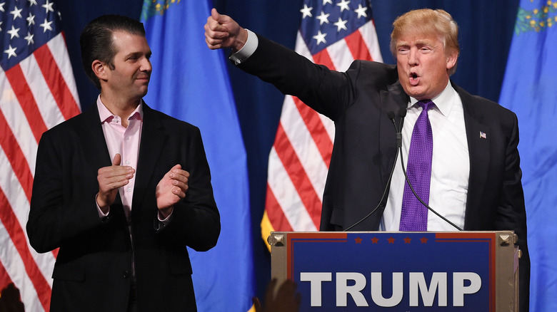 Donald Trump Jr. looking on as his father Donald Trump waves