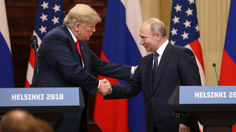 Donald Trump and Vladimir Putin shaking hands in 2018