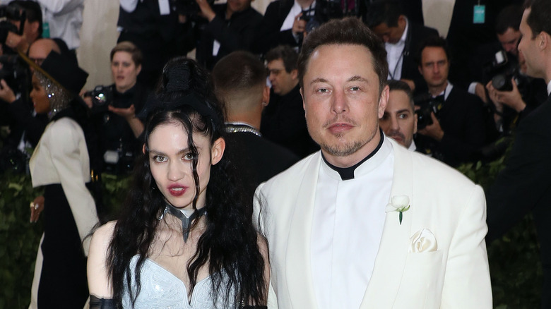 Elon Musk white suit with Grimes white dress
