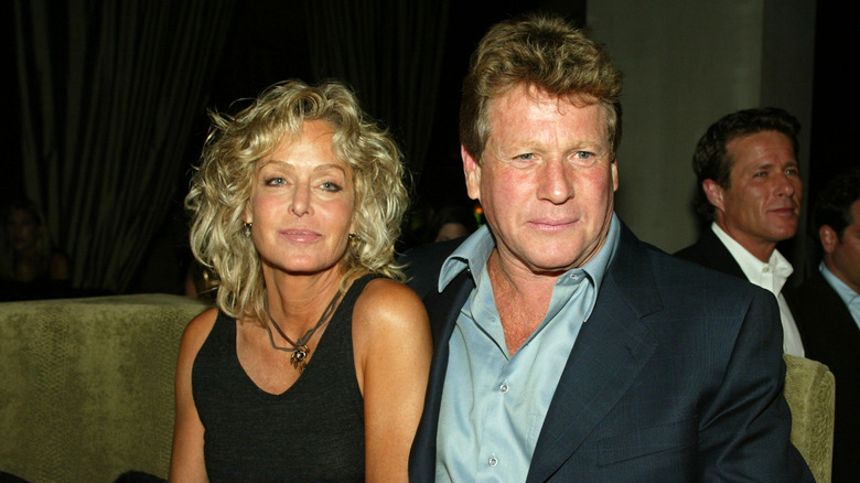 Farrah Fawcett and Ryan O'Neal sitting in 2003