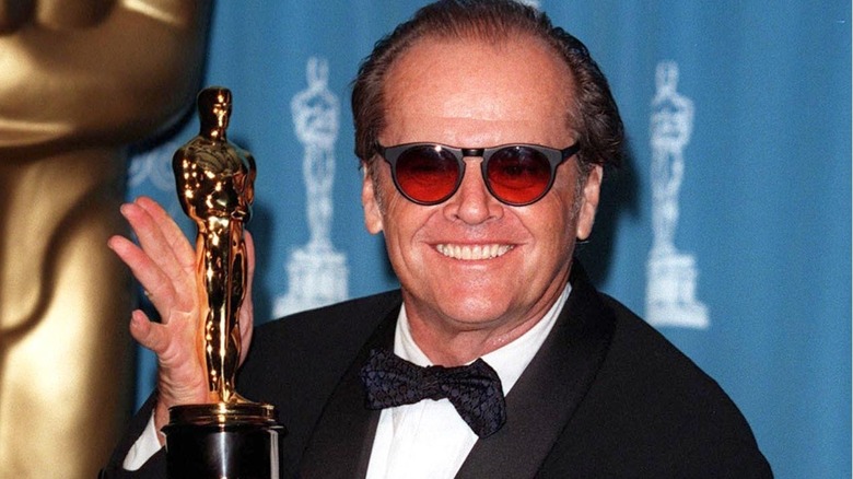 Jack Nicholson smiling and holding an Oscar