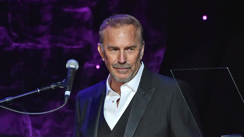 Kevin Costner behind a microphone