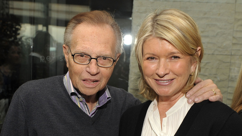 Larry King smiles alongside Martha Stewart at an event