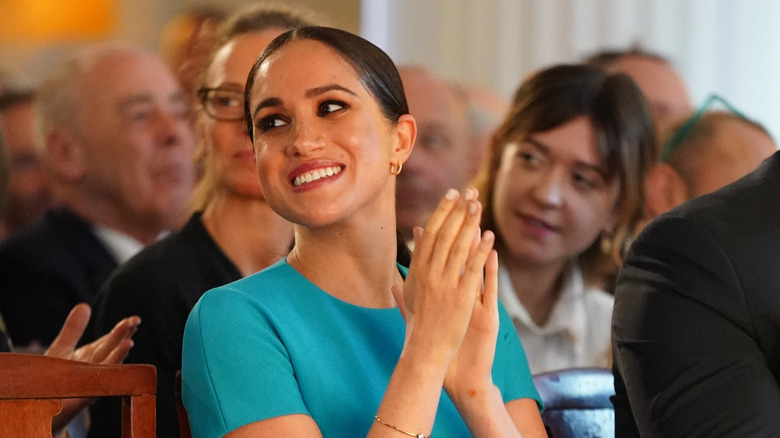 Meghan markle smiling and clapping