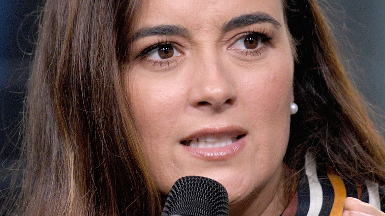 Cote de Pablo speaking into microphone