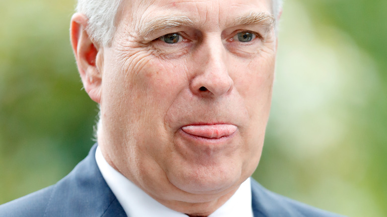 Prince Andrew sticks his tongue out