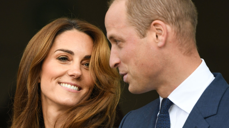 Kate Middleton and Prince William smiling and chatting