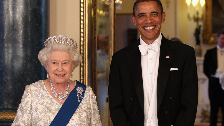 Queen Elizabeth II and Barack Obama smile at an engagement