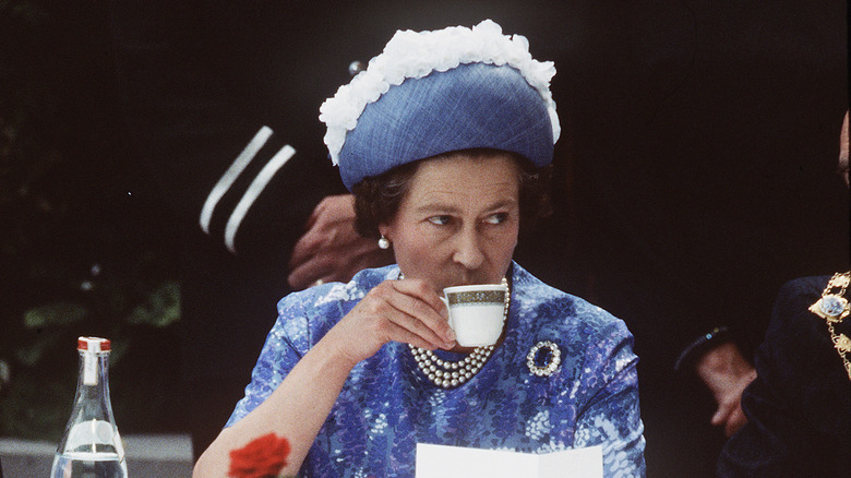 Queen Elizabeth II sipping tea