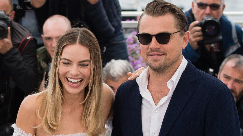 Leonardo DiCaprio and Margot Robbie pose at an event