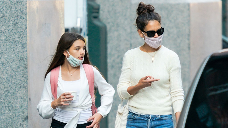 Suri Cruise and Katie Holmes wearing masks and walking around in New York City