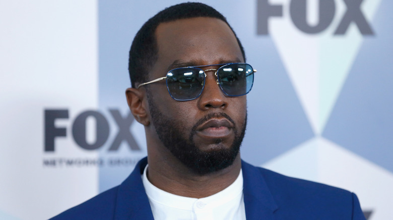 Sean Combs wearing a blue blazer and sunglasses