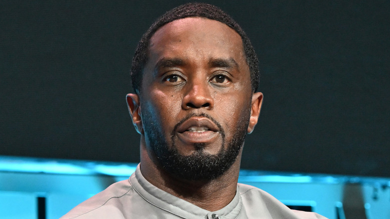 Sean Combs wearing a gray shirt with a serious expression on his face