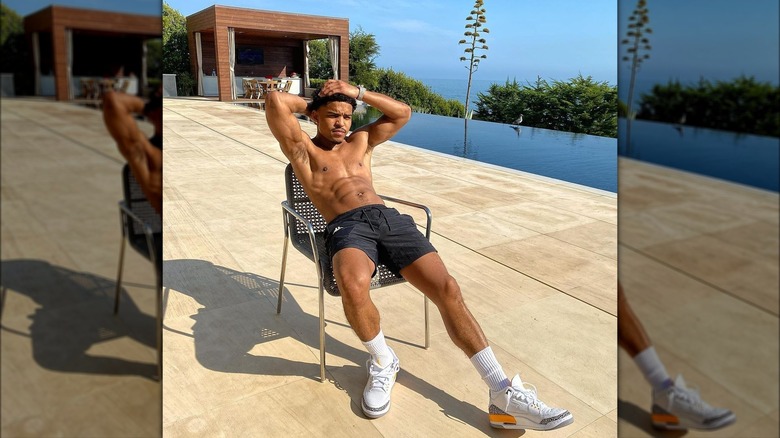Justin Combs sits by pool