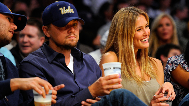 Leo DiCaprio and Bar Rafaeli sitting